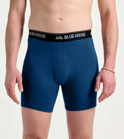 Men’s blue boxer briefs with black logo waistband, front view on model