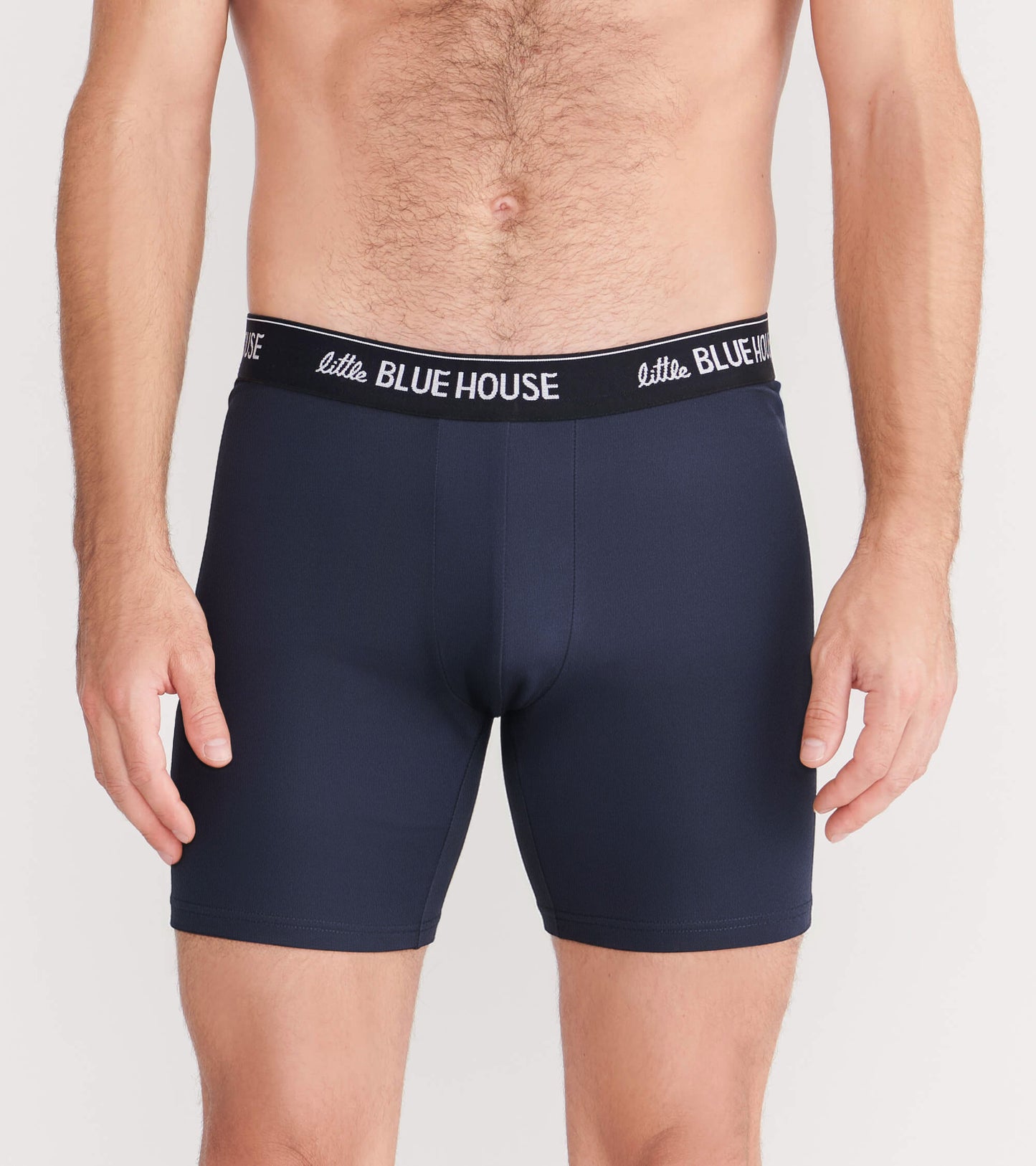 Front view of solid navy boxer briefs with black waistband and white logo text