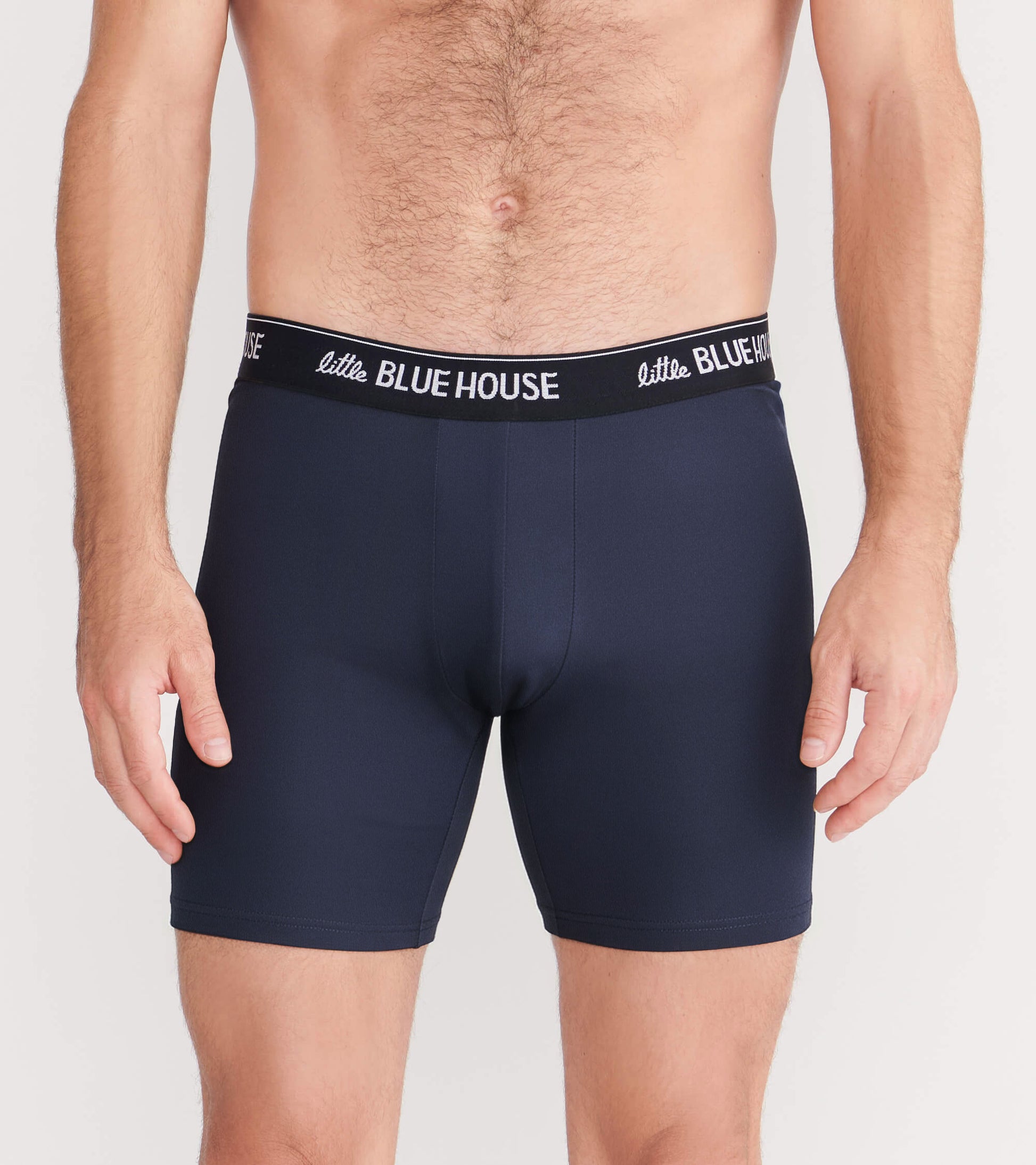 Front view of solid navy boxer briefs with black waistband and white logo text