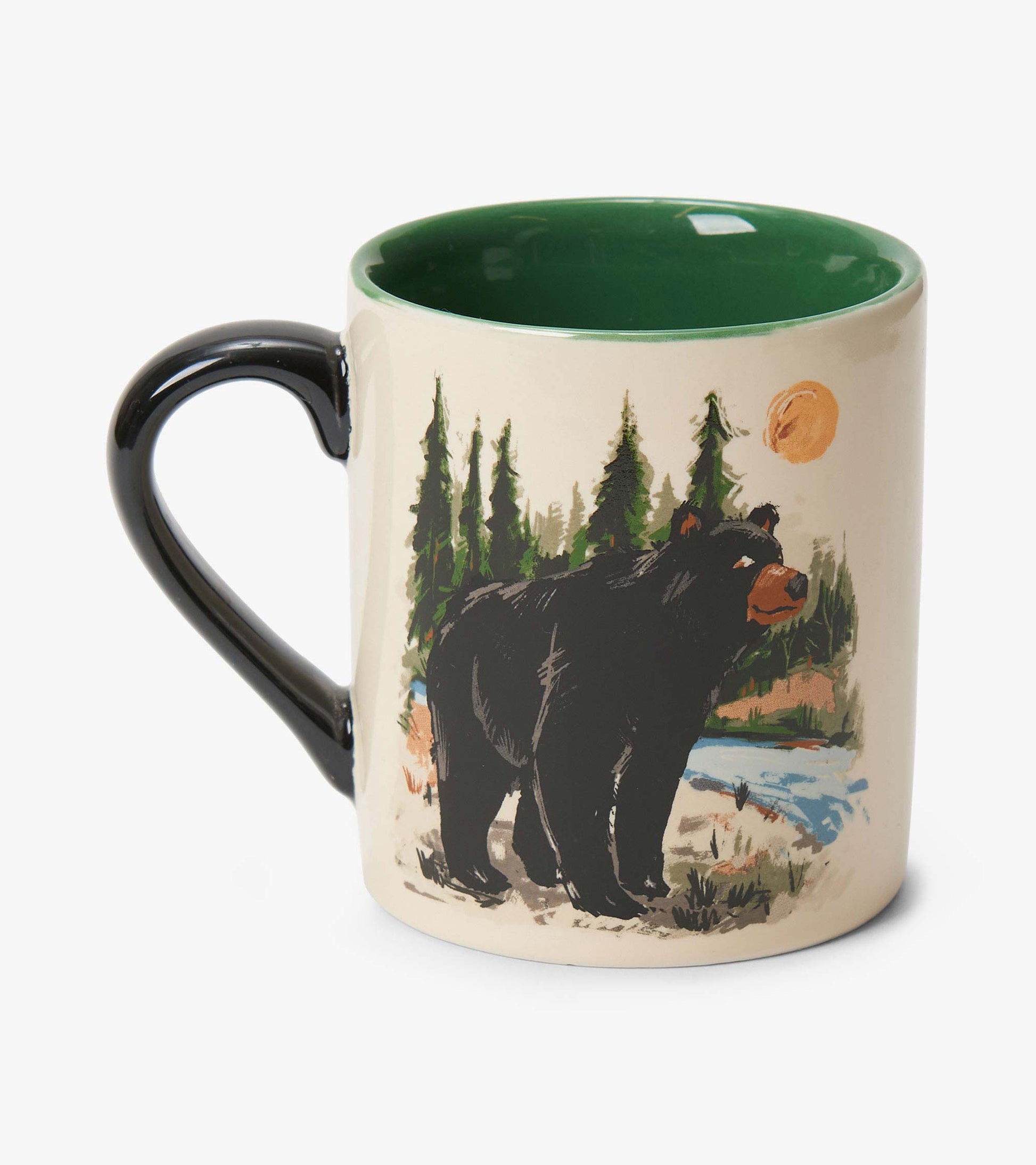 Ceramic mug with black handle, green interior, and bear forest print on cream background