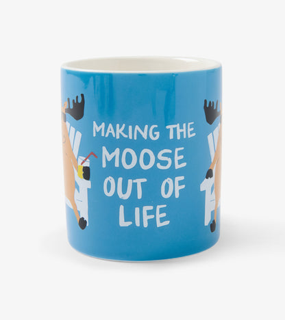 Blue ceramic mug with white interior and moose graphic, reading “Making the Moose Out of Life”
