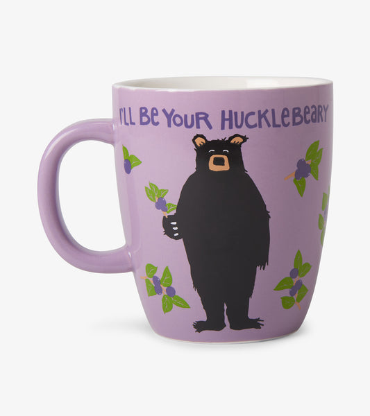 Lavender ceramic mug with handle, bear and blueberry design, and text saying “I’ll Be Your Hucklebeary”
