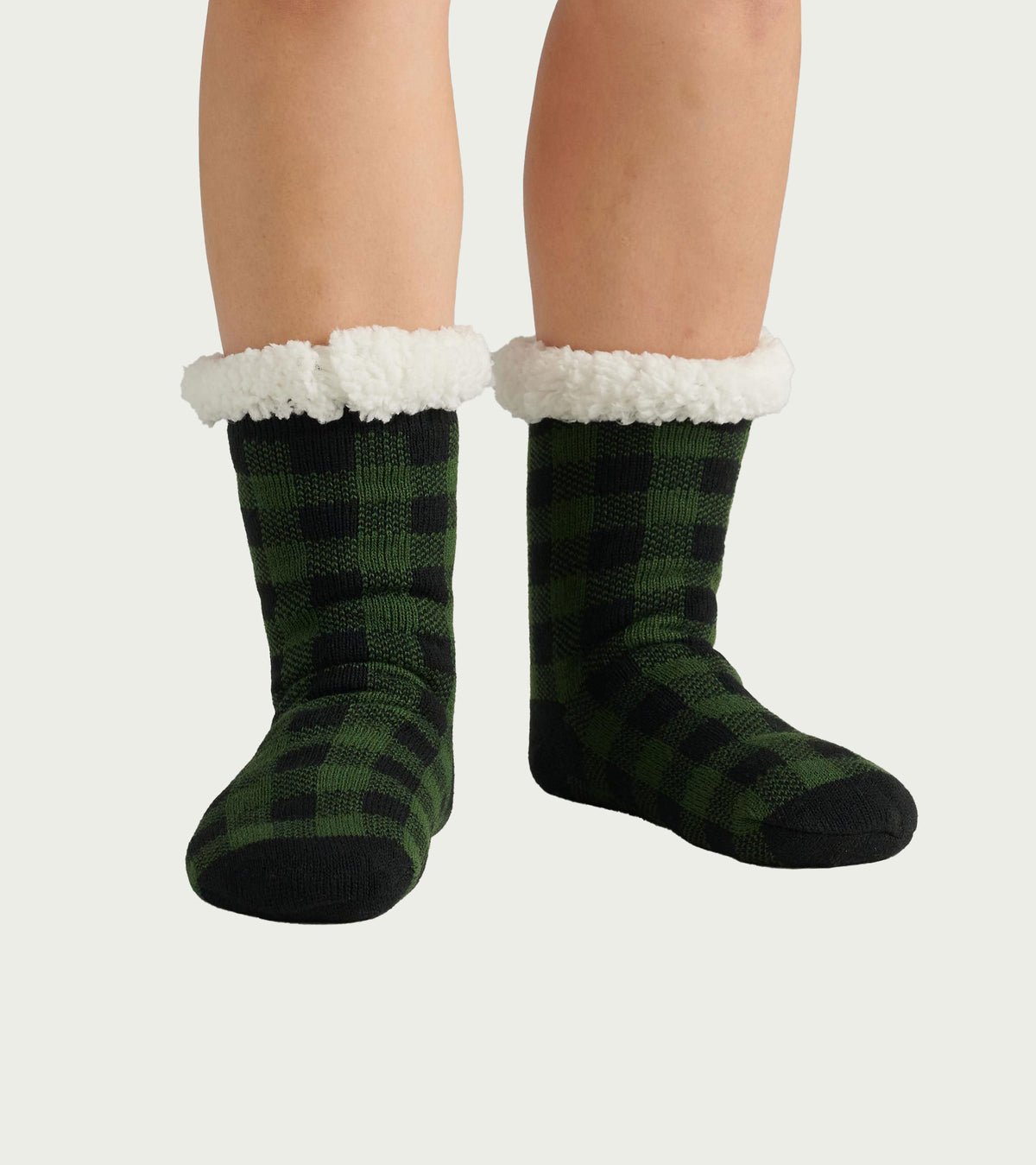 Forest green and black plaid women's cabin socks with a soft white Sherpa lining at the cuff.