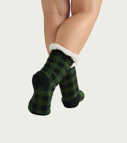 Forest green plaid women's socks with a cozy white Sherpa lining, perfect for cabin wear.