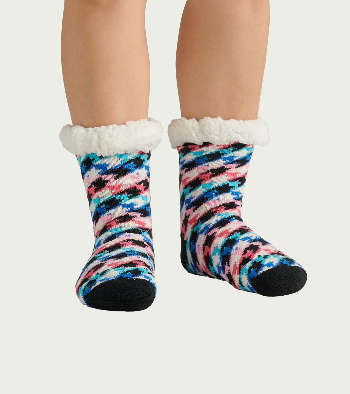 Colorful houndstooth pattern women's socks with a soft white Sherpa lining at the cuff, designed for cozy wear.