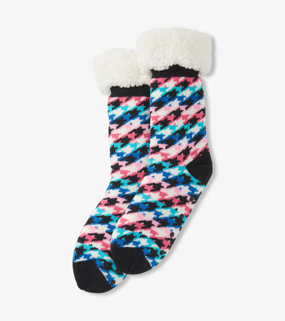 Colorful houndstooth pattern socks with a soft white Sherpa lining at the cuff, designed for cozy comfort.