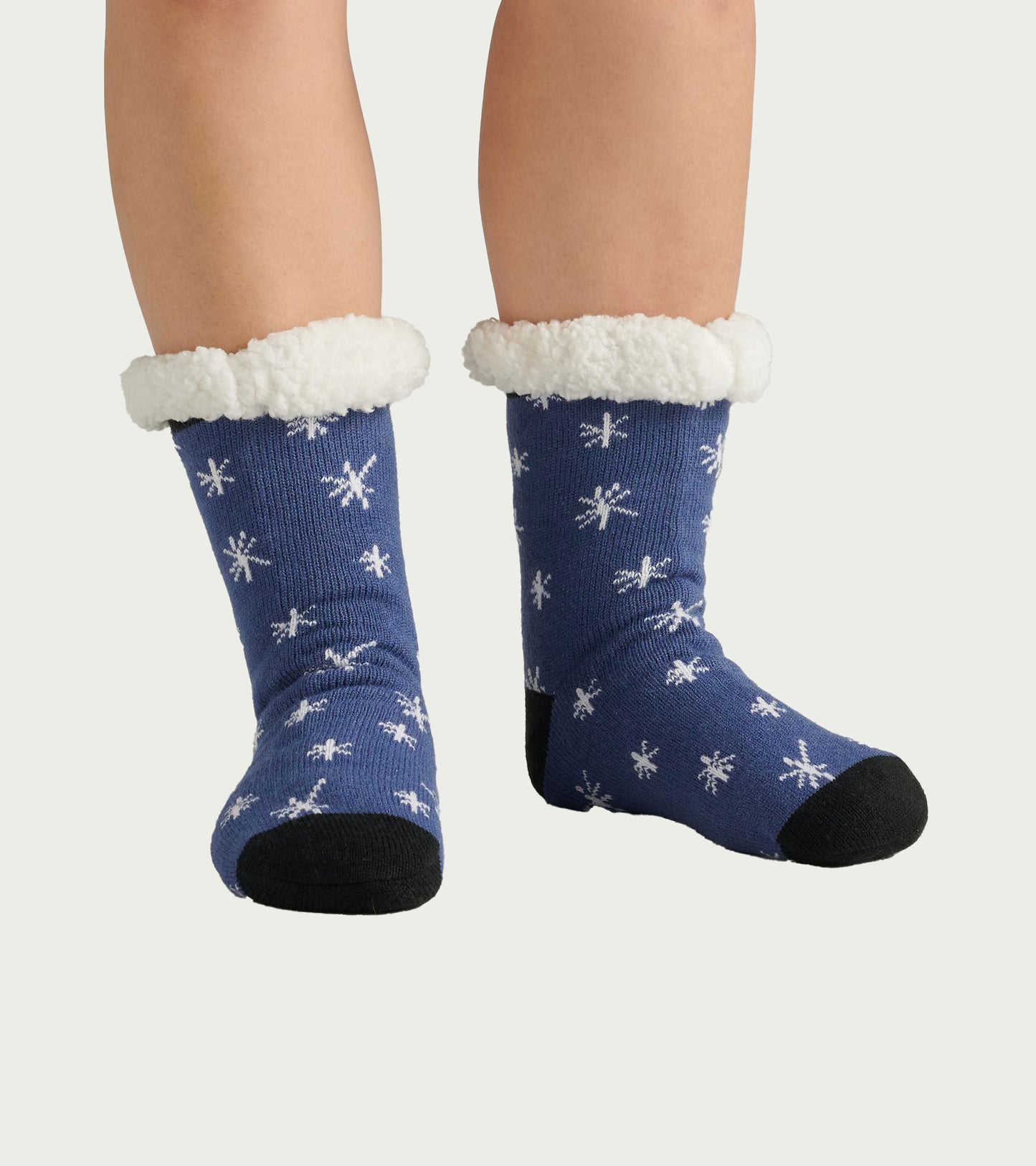 Blue socks with white snowflake pattern and fluffy white cuffs, designed for warmth and comfort. One size fits all.