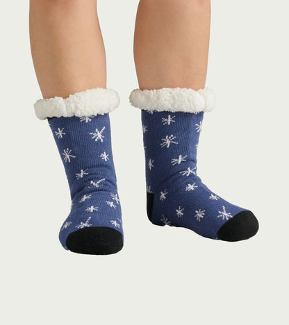 Blue socks with white snowflake pattern and fluffy white cuffs, designed for warmth and comfort. One size fits all.