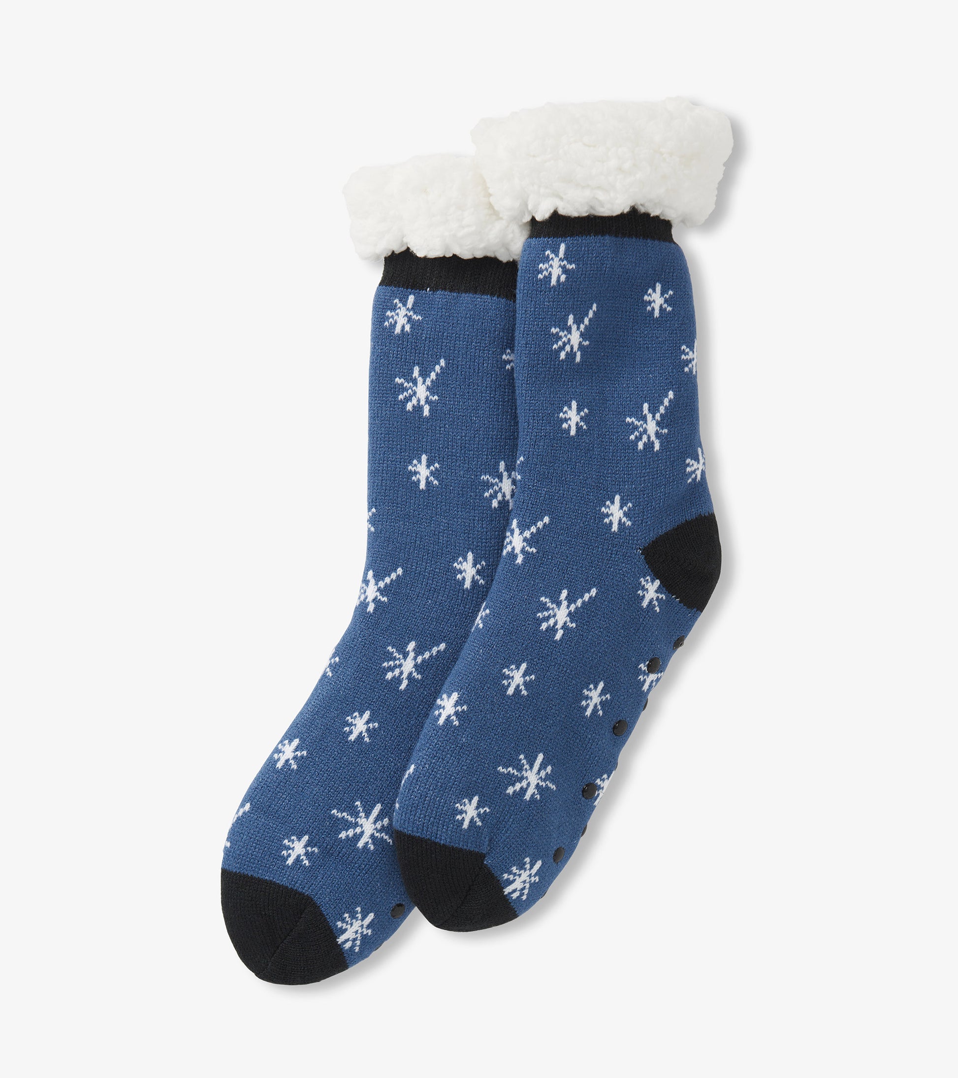 Blue cabin socks with white snowflake pattern and fluffy white lining at the top, featuring black accents on the toe.