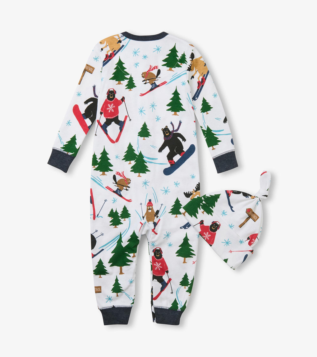 Back view of baby sleeper and knotted hat with skiing animal and evergreen print on white