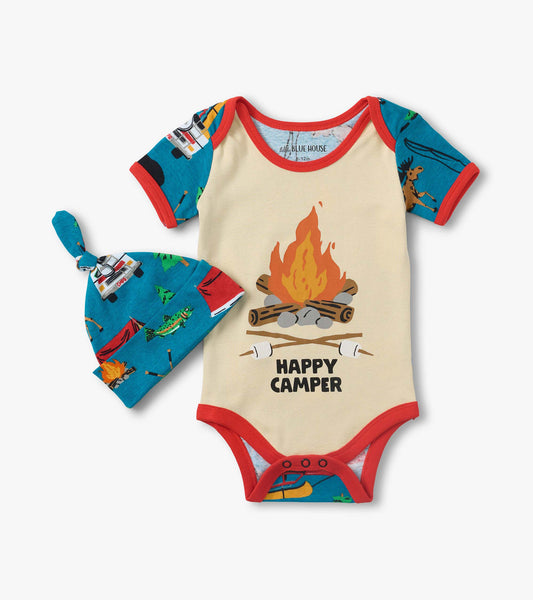 Cream baby bodysuit with red trim, blue camping-print sleeves, and matching knotted hat with campfire pattern.
