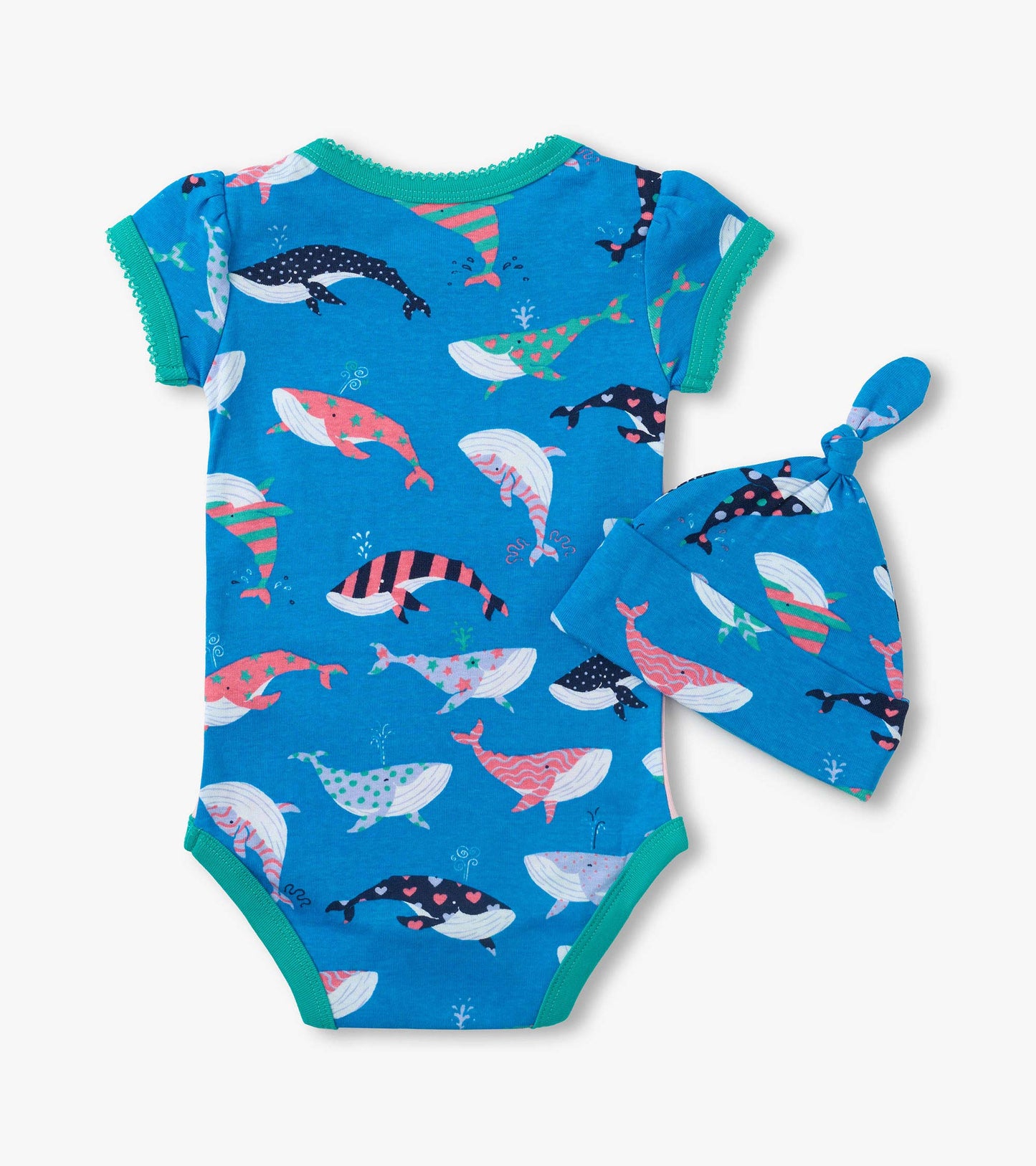 Blue baby bodysuit with whale print, green trim, and matching knotted hat on white background