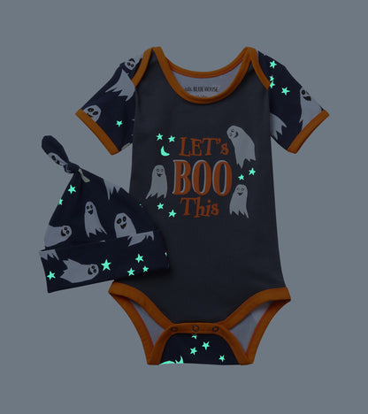 Baby ghost-print bodysuit and hat set shown in the dark with glowing stars and moon details