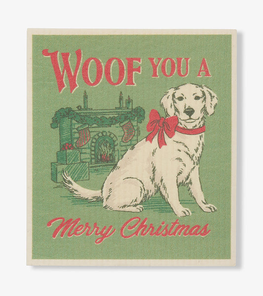Green dishcloth with 'Woof You a Merry Christmas,' a dog in a red bow, fireplace, stockings and presents