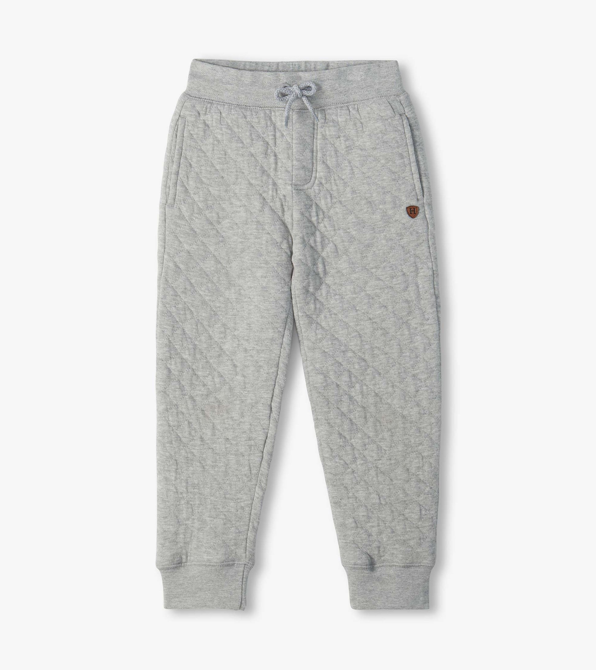 Grey quilted jogger pants with drawstring waist, side pockets, tapered legs, and ribbed cuffs