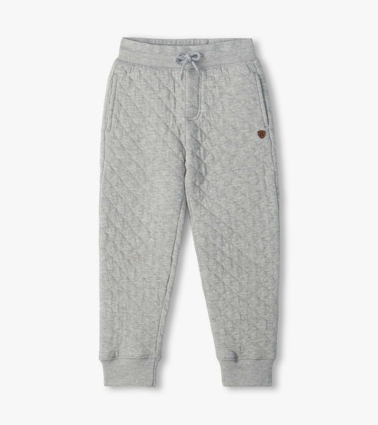 Grey quilted jogger pants with drawstring waist, side pockets, tapered legs, and ribbed cuffs