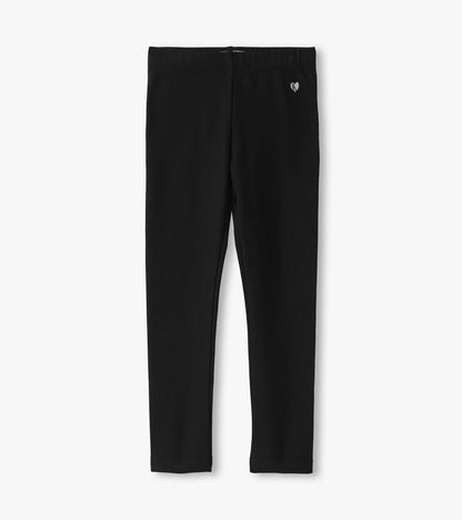 Black cozy leggings with a stretchy waistband and a small heart logo, suitable for casual wear.