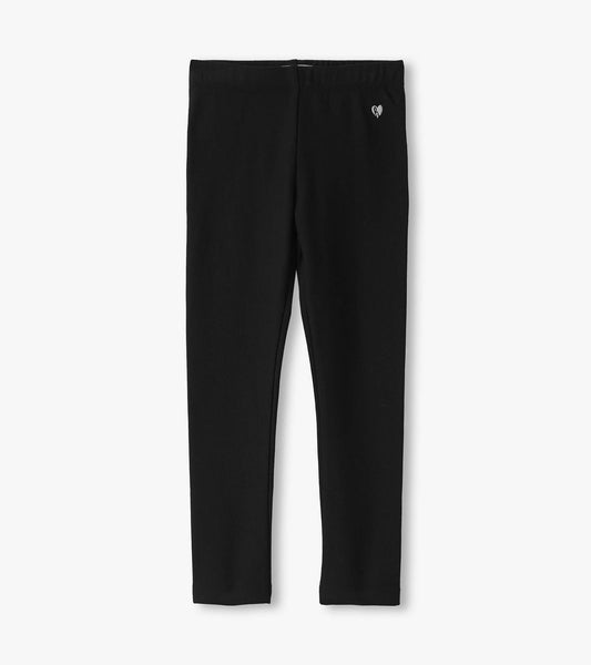 Black cozy leggings with a stretchy waistband and a small heart logo, suitable for casual wear.