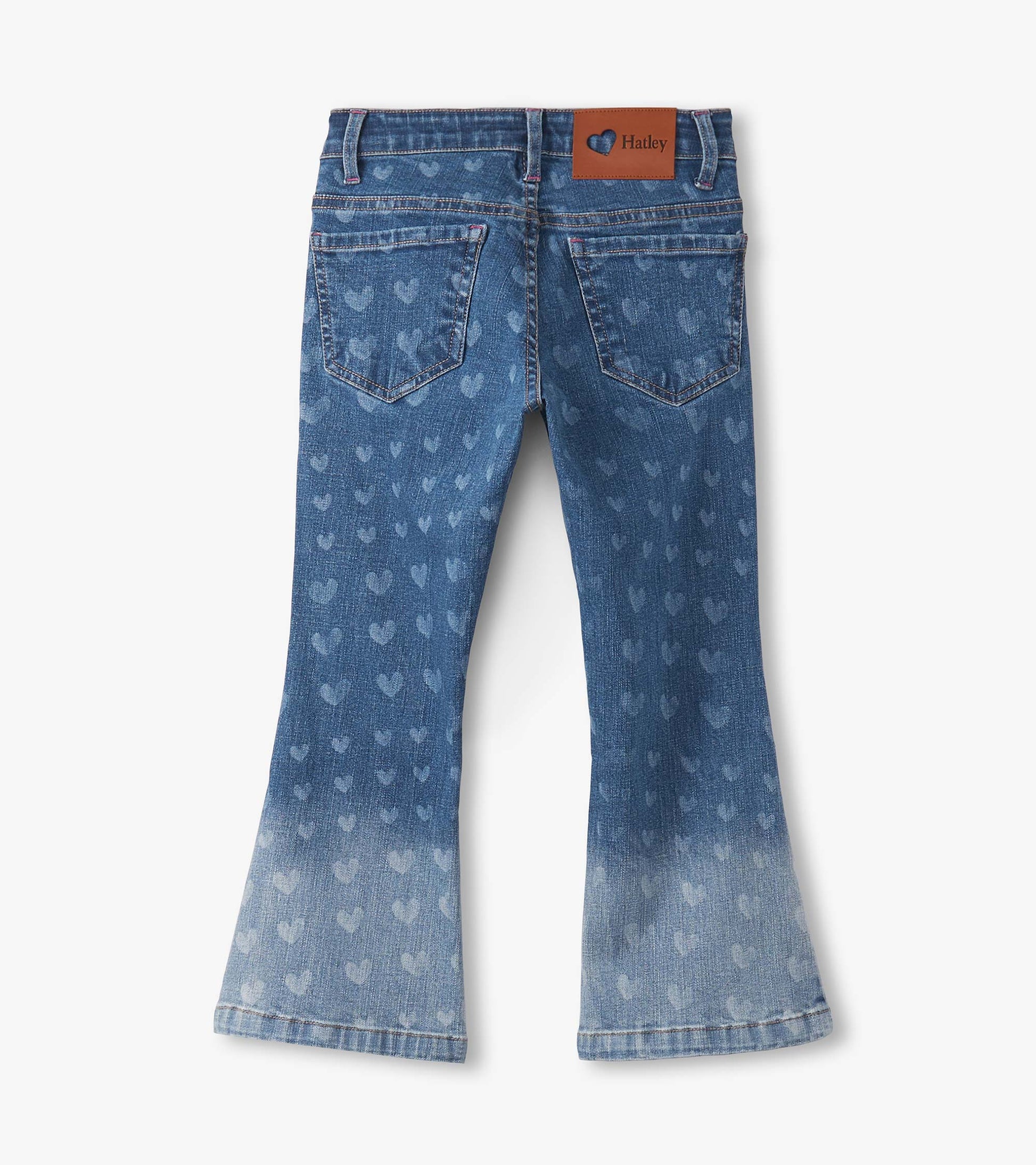 Flared leg denim jeans in light blue with heart patterns, featuring a faded wash and back pockets.