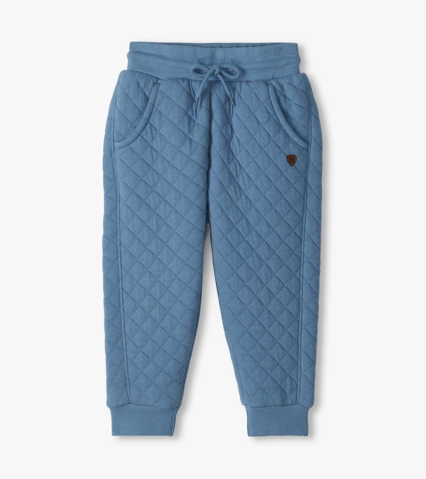 Blue quilted jogger pants with diagonal stitching, front pockets, drawstring waist, and ribbed cuffs
