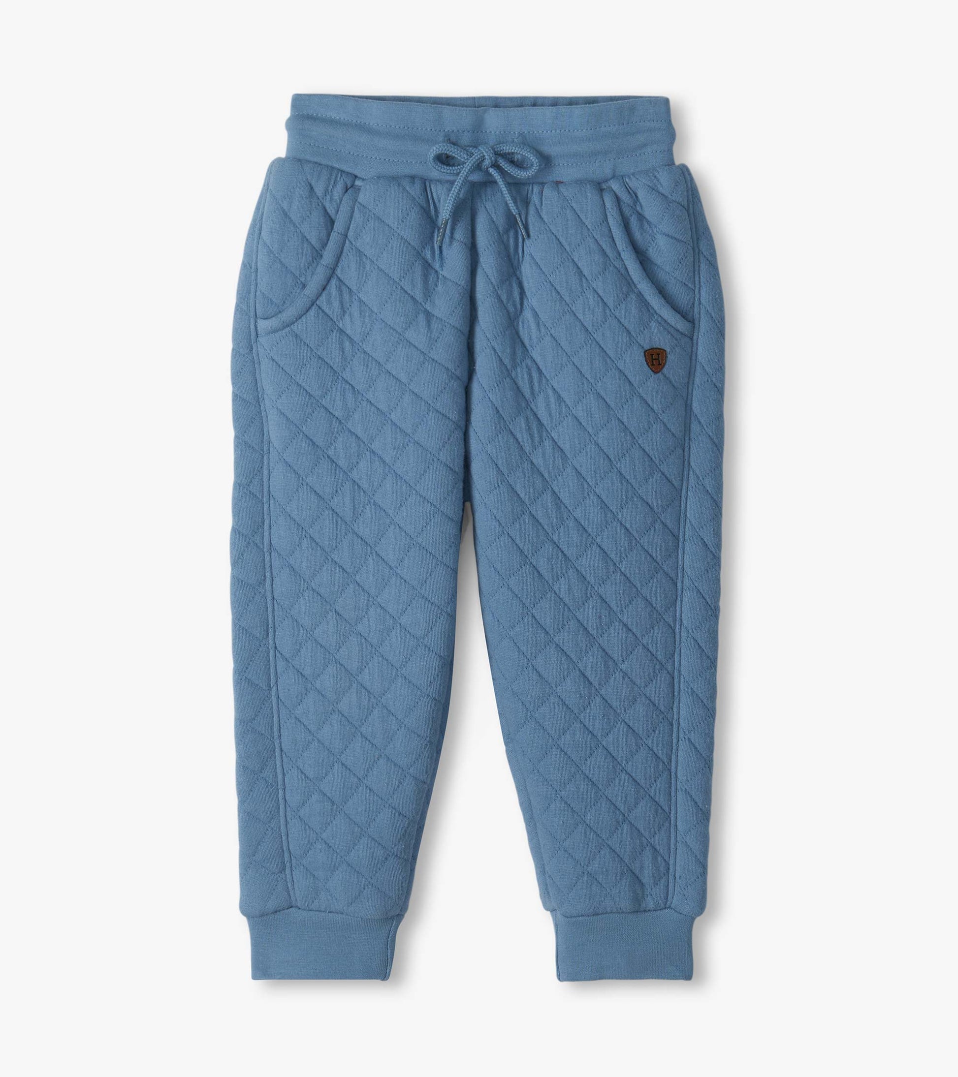 Blue quilted jogger pants with diagonal stitching, front pockets, drawstring waist, and ribbed cuffs