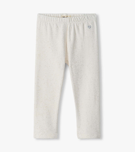 Infant cream leggings with an elastic waistband and scattered metallic speckles