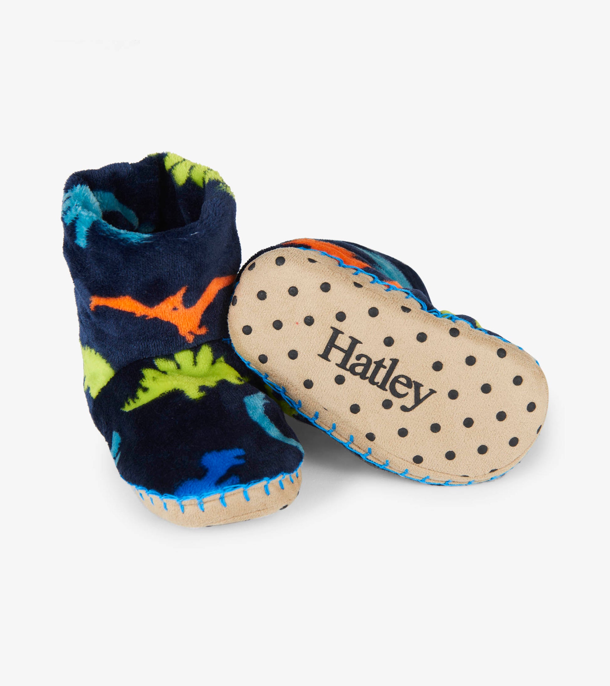 Navy fleece slippers featuring colorful dinosaur patterns and a soft, non-slip sole. Ideal for cozy indoor wear.