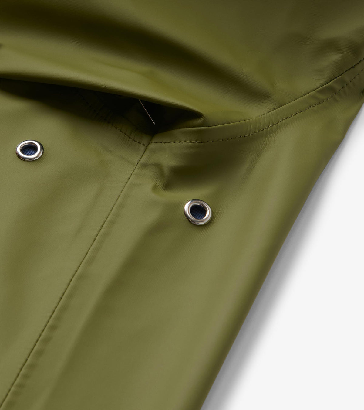 Close-up of loden green rain jacket hood with silver eyelets and stitched seam detail
