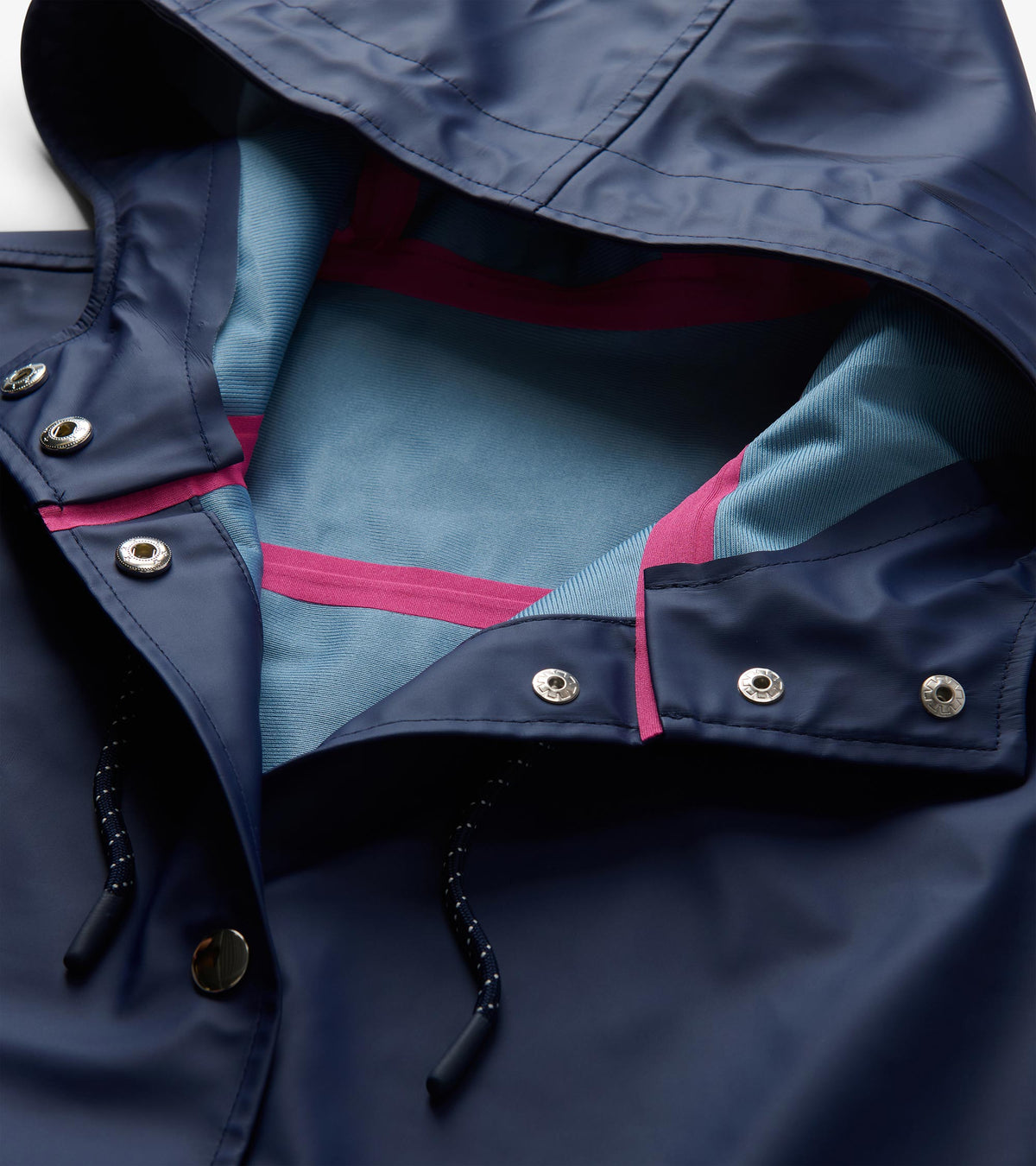 Close-up of patriot blue hood interior with light blue lining, pink seam tape, snaps, and drawcord