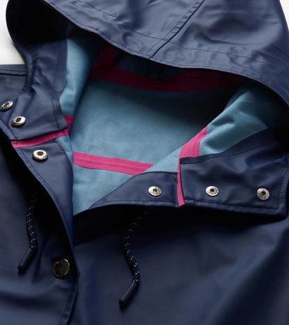 Close-up of patriot blue hood interior with light blue lining, pink seam tape, snaps, and drawcord