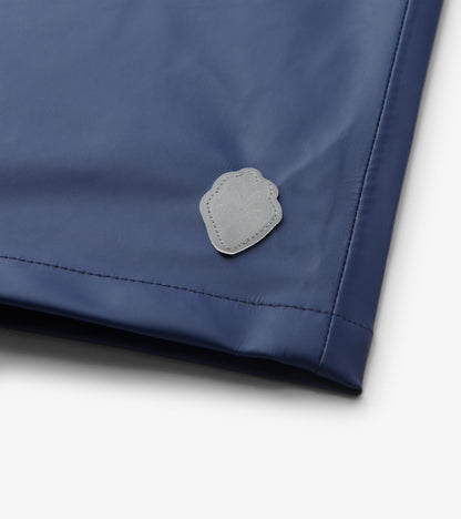 Close-up of patriot blue rain jacket hem with small gray logo patch