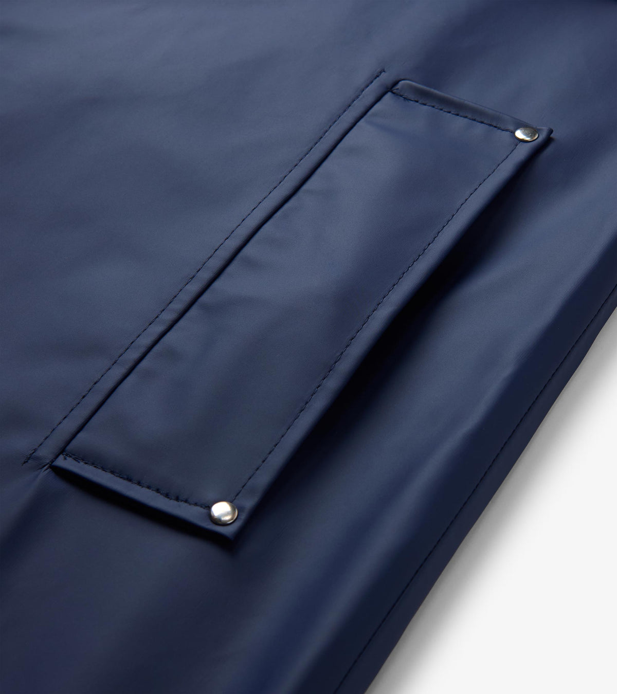Close-up of patriot blue rain jacket front pocket with silver rivets