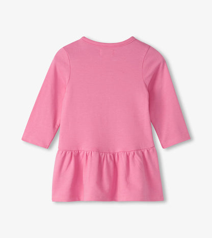 Pink long-sleeve toddler dress with a gathered flounce skirt, shown from the back