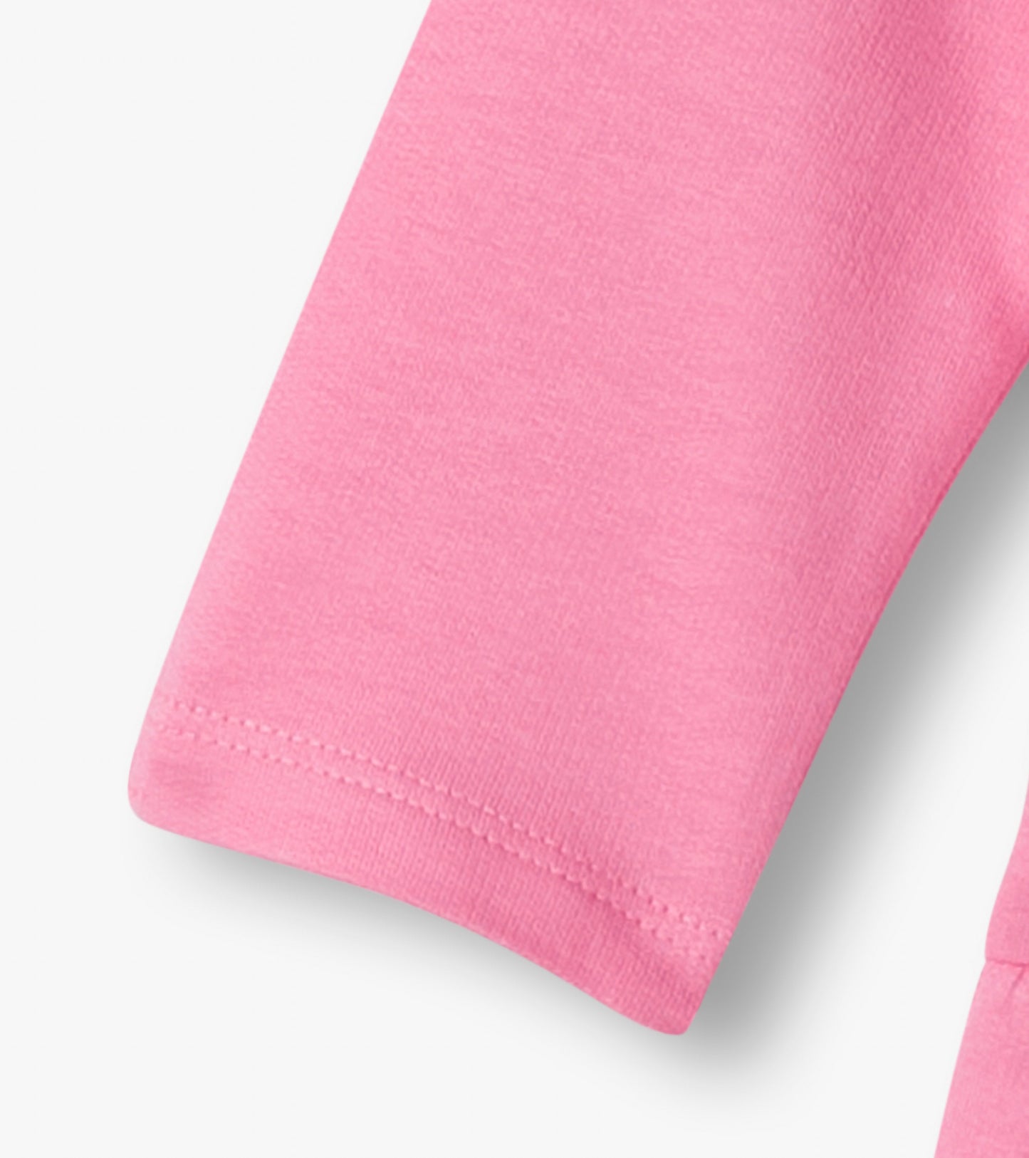 Close-up of pink knit fabric with stitched hem on a toddler dress sleeve