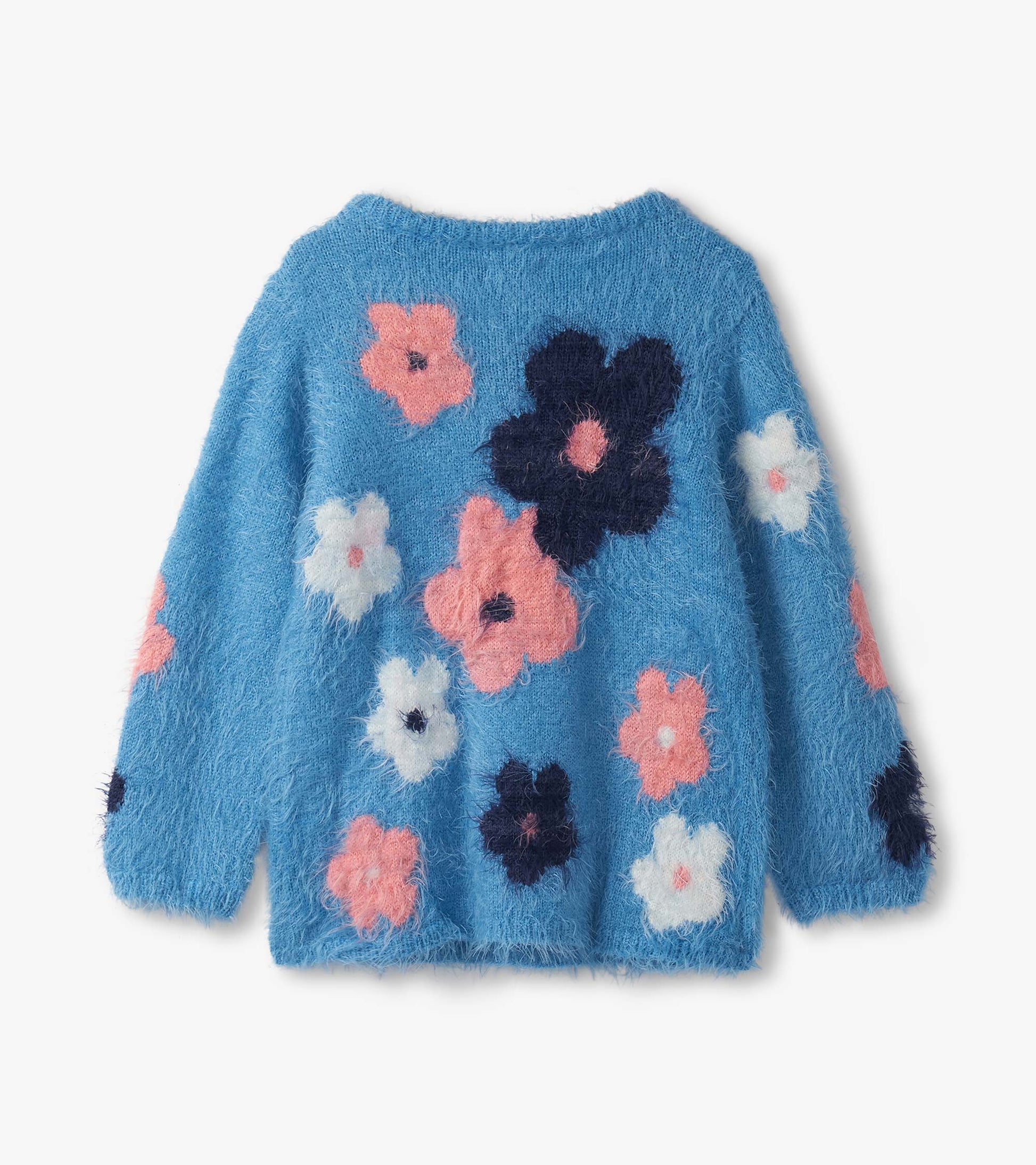 Furry blue sweater featuring colorful floral clusters in pink, white, and navy, with long sleeves and a round neckline.