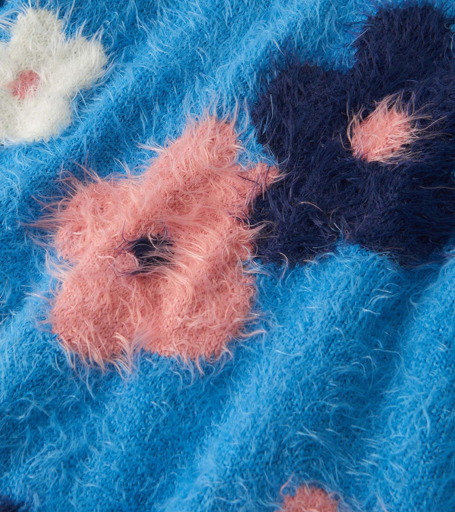 Furry blue sweater featuring colorful floral clusters in pink, white, and navy, ideal for casual wear.