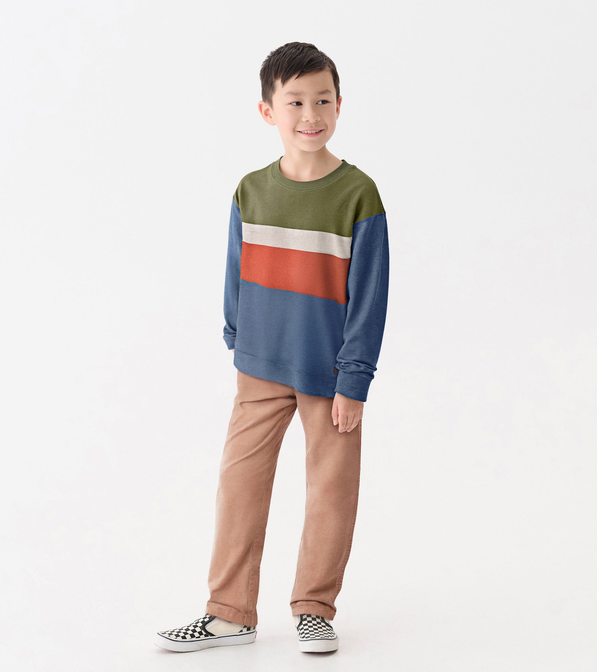 Boys' long-sleeve sweatshirt featuring a color block design in green, white, orange, and blue, paired with beige pants.