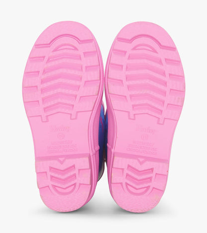 Pink rubber soles of girls' ballet school matte rain boots with textured grip pattern.