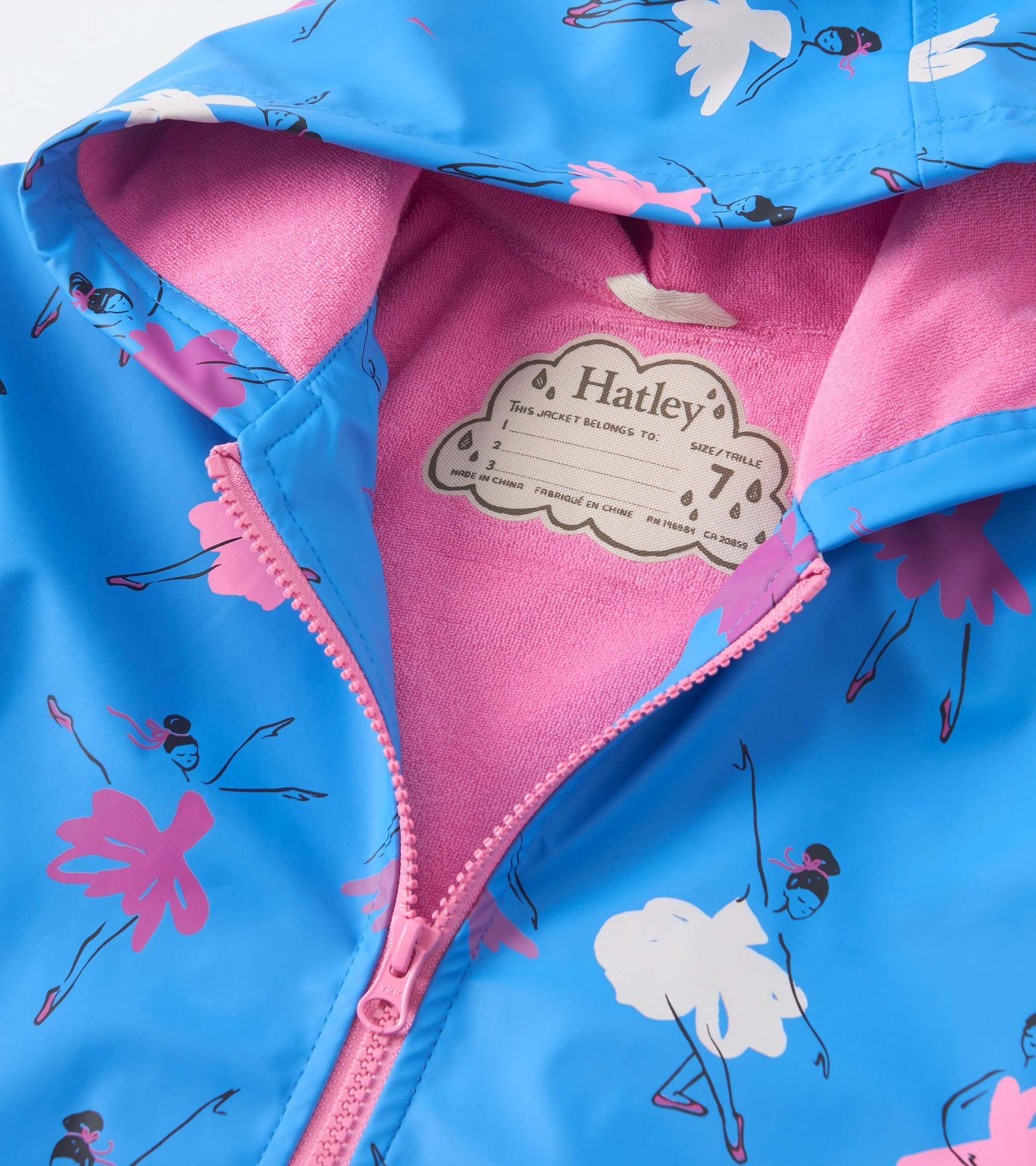 Blue zip-up rain jacket with ballet dancer print and pink lining, featuring a hood and front zipper.