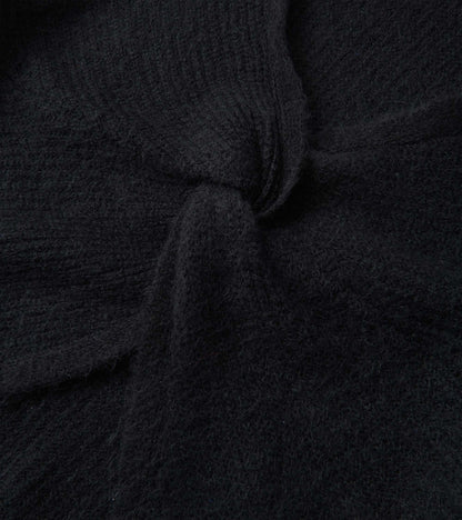 Black cross over sweater with a textured knit pattern, showcasing a soft and cozy fabric.