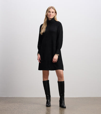 Black long-sleeve turtleneck sweater dress with a relaxed fit and beige cuff trim, front view