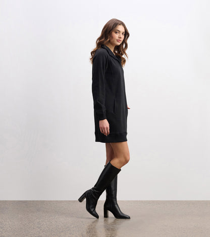 Black notch neck dress with long sleeves and side pockets, styled with knee-high black boots.