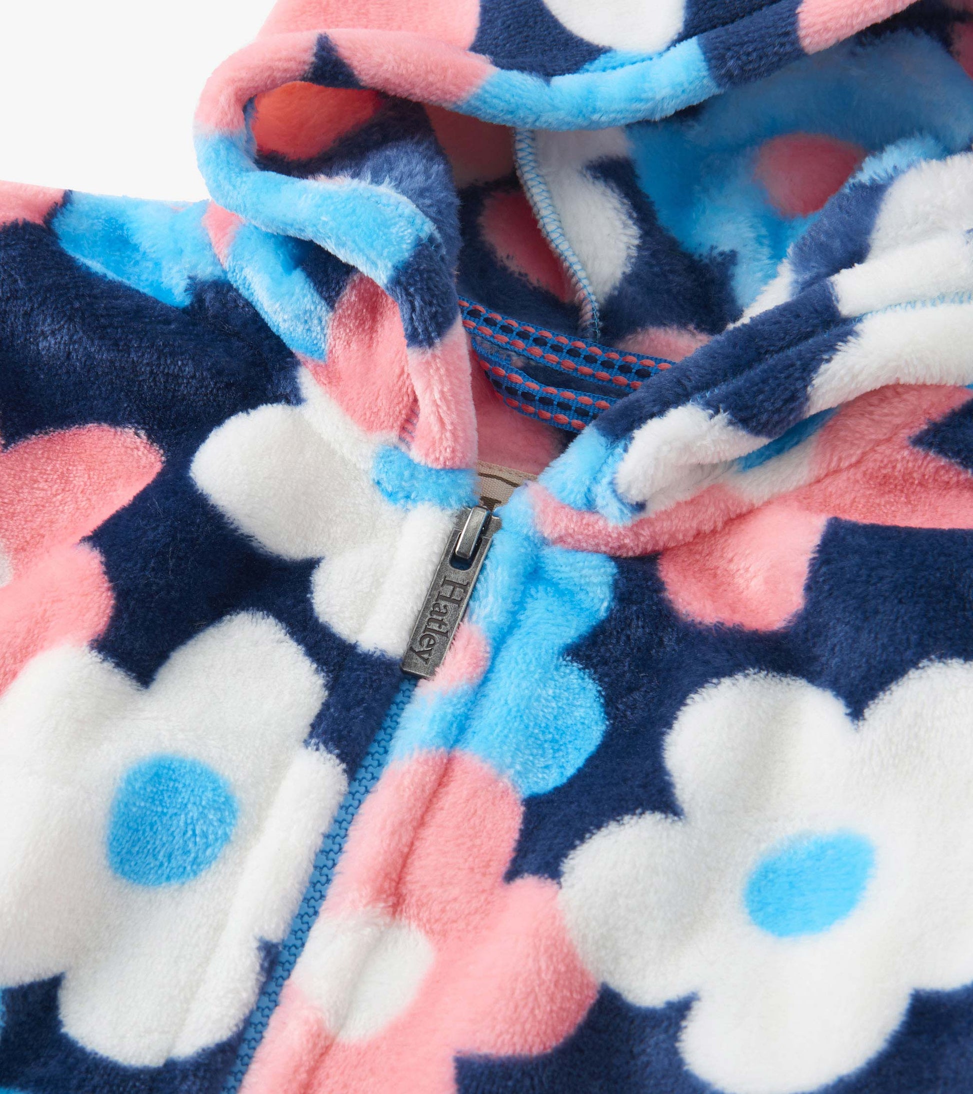 Fleece zip-up hoodie featuring a navy background with large pink, white, and blue flowers. Cozy and warm design.