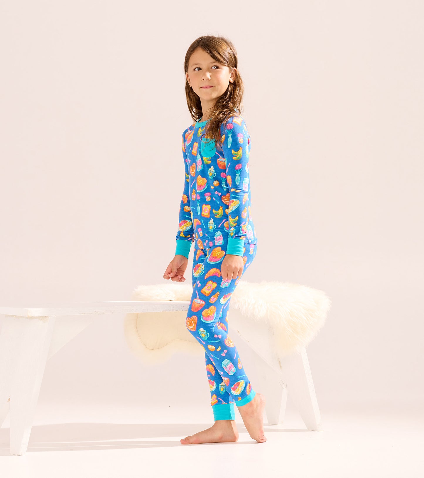 Blue bamboo pajama set for girls featuring colorful breakfast-themed prints, long sleeves, and matching pants.