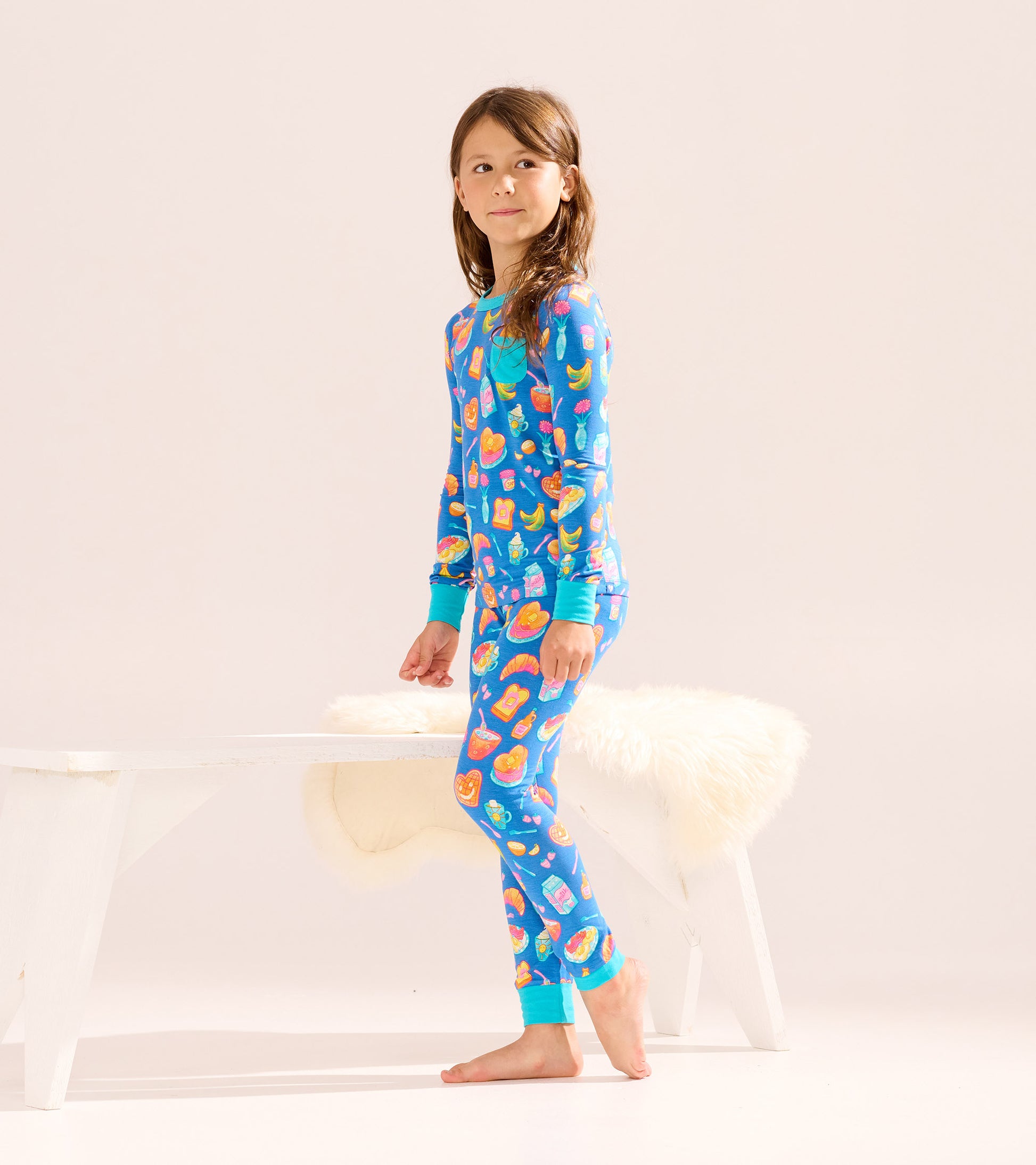 Blue bamboo pajama set for girls featuring colorful breakfast-themed prints, long sleeves, and matching pants.