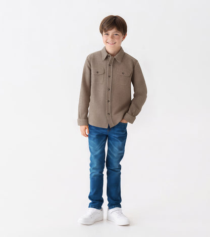 Brown herringbone button-down shirt with two chest pockets, worn by a boy with blue jeans and white sneakers.