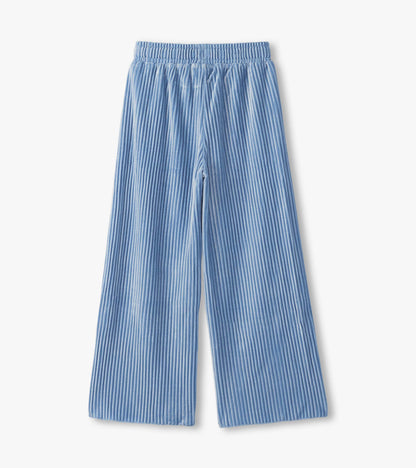 Cornflower blue pleated velour relaxed pants with an elastic waistband and wide legs.