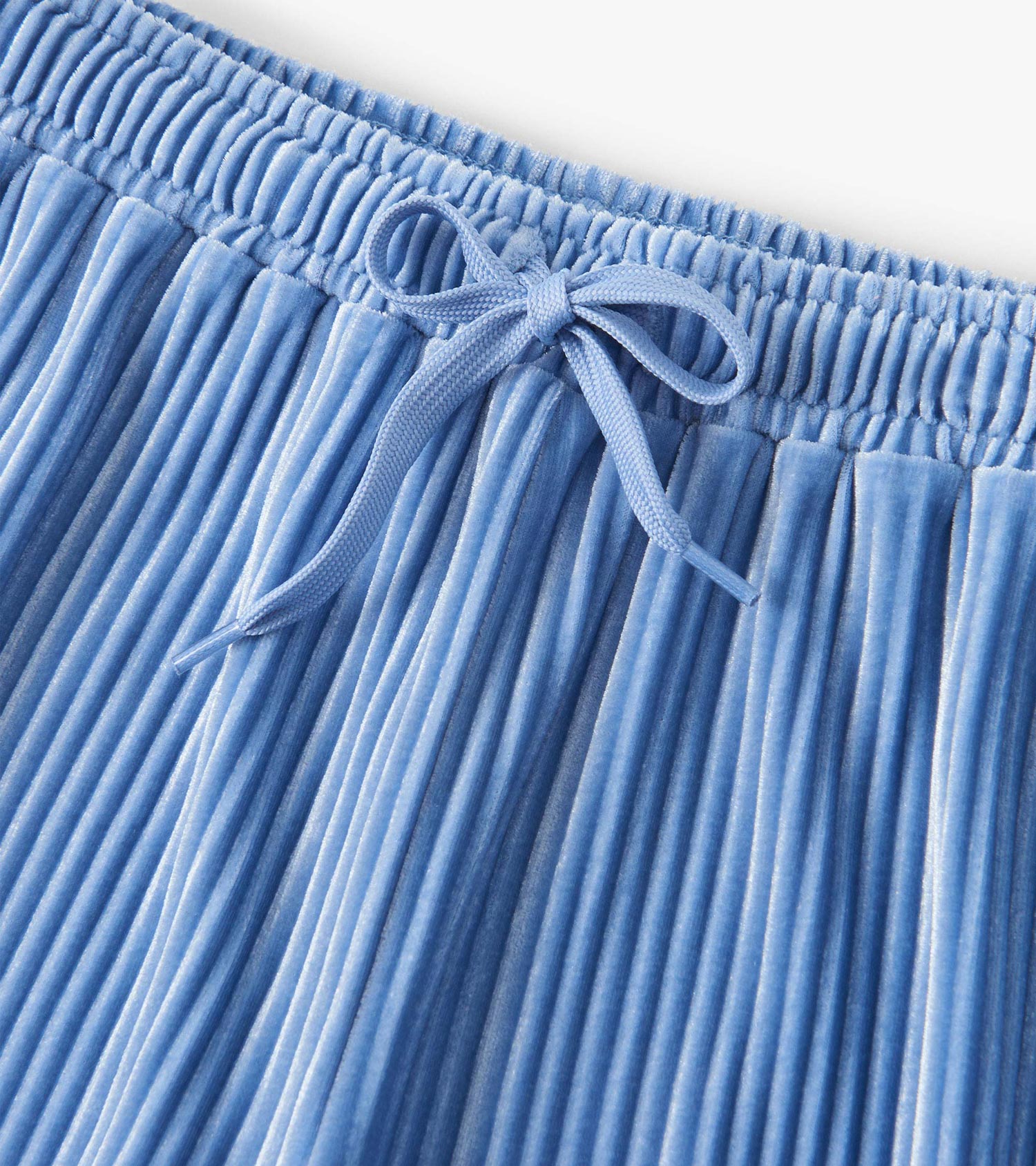 Cornflower blue pleated velour pants with an elastic waistband and drawstring detail. Ideal for relaxed wear.