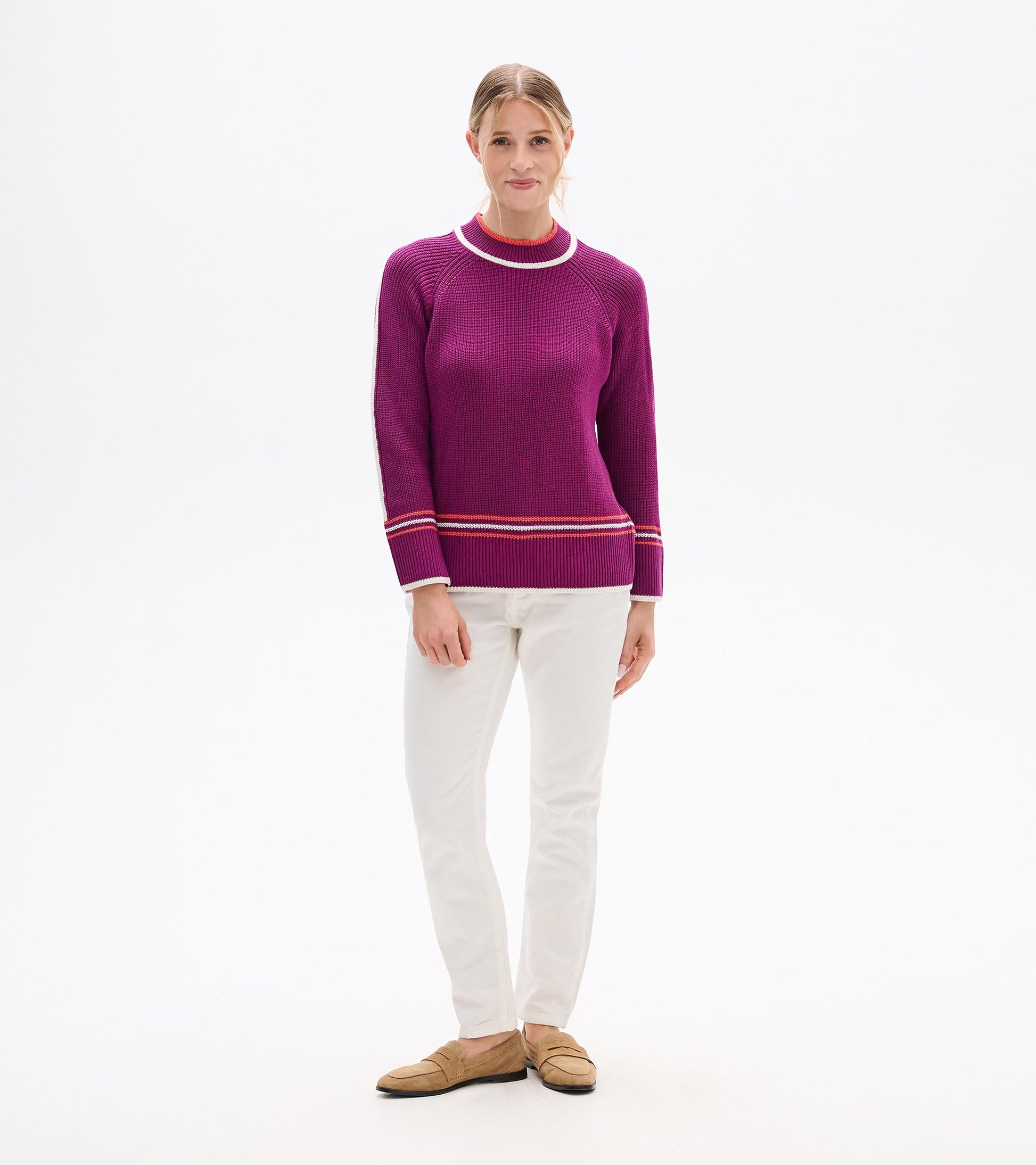 Raglan pullover in crushed grape with contrasting stripes, featuring a relaxed fit and ribbed texture, worn with white pants.