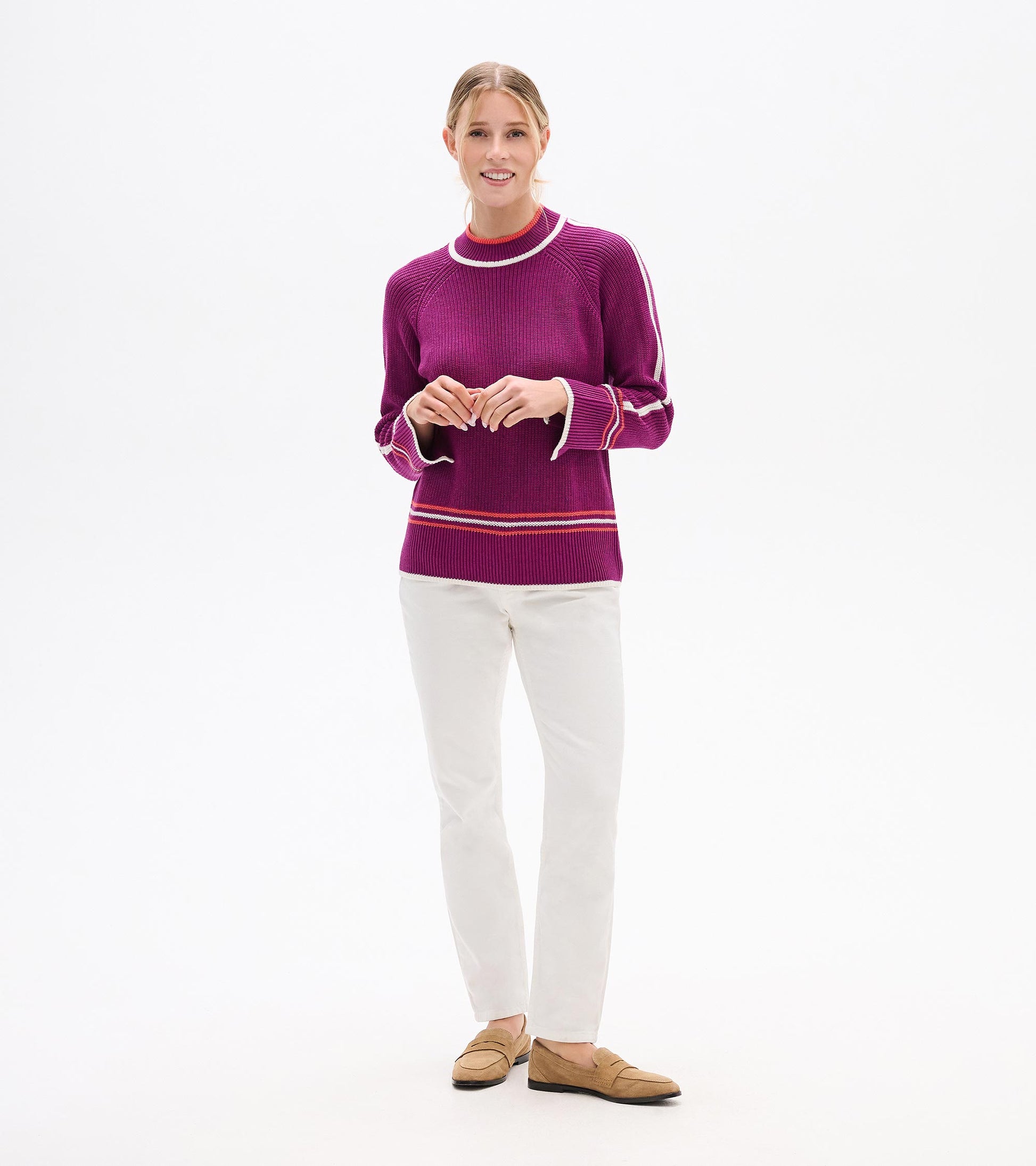 Crushed grape pullover with ribbed texture and contrasting trim, paired with white pants and loafers.